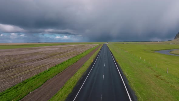 Endless Road Into the Cloudy Mountains and Hills of Iceland During Sunny Cloudy Weather