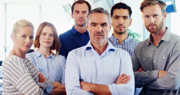 Team of business executive standing with arms crossed