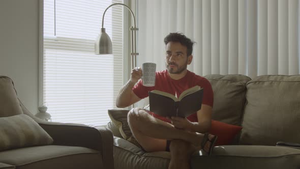 Slow Motion of Man Reading Drinking Coffee and Looking Pensive
