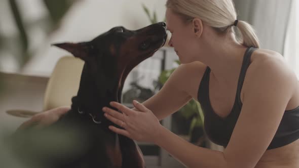 Blond Woman Kissing Doberman Dog