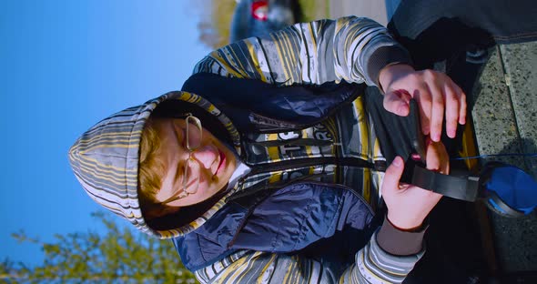 Smartphone Addiction Concept Closeup View of a Teenager Boy with Smartphone and Headphones He