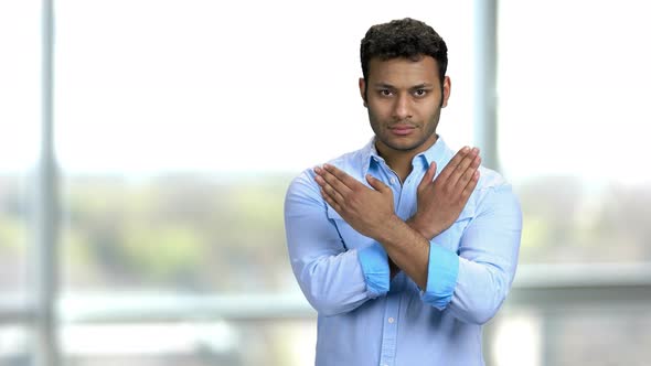 Serious Young Indian Man Showing Cross Stop Gesture with Arms