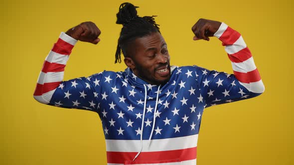 Positive African American Man Showing Strength Gesture Smiling Looking at Camera