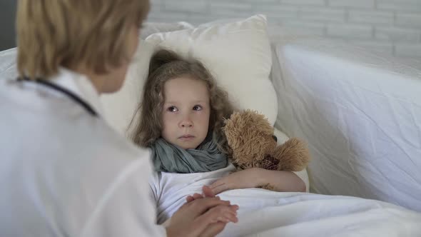 Lady Doctor Comforting Scared Little Child Before Examination, Medical Services