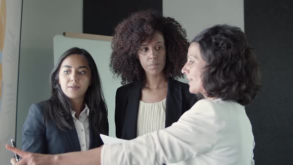 Content Businesswomen Standing and Discussing Project