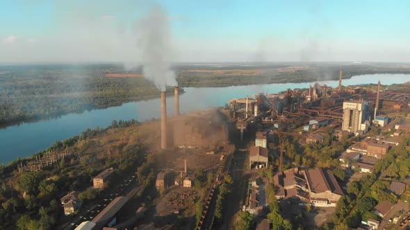 Industrial Plant with Smoking Pipes Near the City