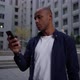 Ethnic Man Using Smartphone on Street - VideoHive Item for Sale