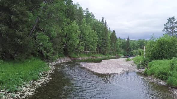 Picturesque forest river and old wooden bridge