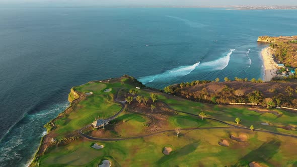 Island Cape Overgrown with Grass and Bushes Stands in the Middle of the Ocean