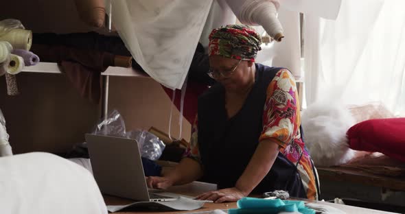 Mixed race woman working at a hat factory