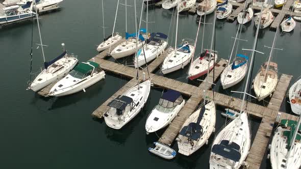 Aerial of marina with sailboats docked.