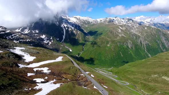 Aerial shot of Nufenenpass Early summer with unmelted patches of snow