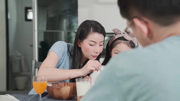 Happiness Asian Japanese family  breakfast at home. young parent and daughter eat