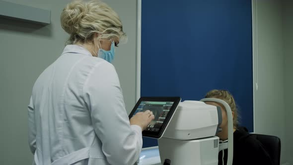 The Ophthalmologist Examines the Patient's Eye and Then Looks Into the Camera