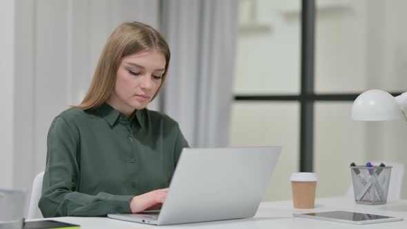 Young Woman Working on Laptop in Office 