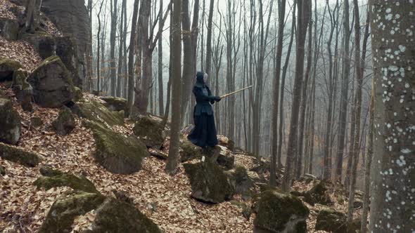 Concentrated Man with a Japanese Sword, a Katana Practicing Iaido in a Pine Forest, Wide Angle