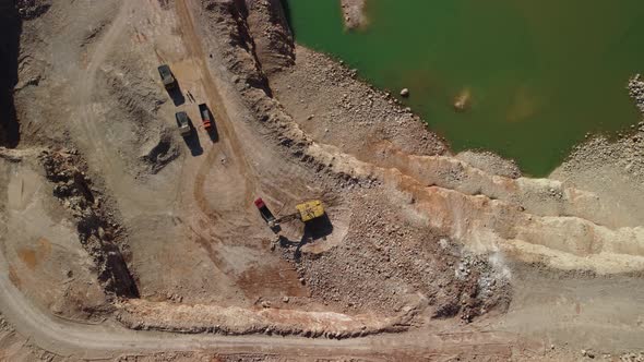 Aerial View of Industrial Opencast Mining Quarry with Lots of Machinery at Work Extracting Fluxes