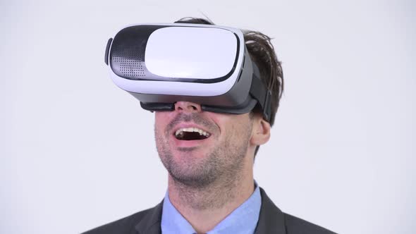 Head Shot of Young Hispanic Businessman Using Virtual Reality Headset