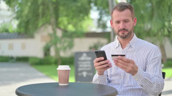 Successful Online Payment on Smartphone By Middle Aged Man