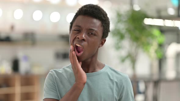 Young African Man with Laptop Having Toothache 