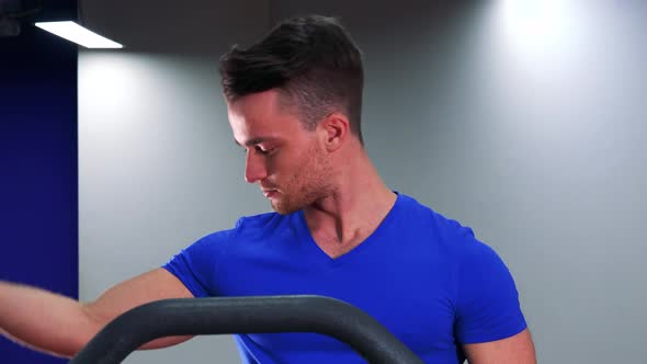 A Young Fit Man Shows of His Muscles To the Camera in a Gym - Closeup