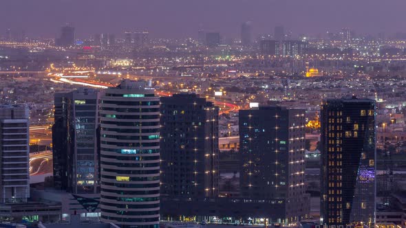 Dubai's Business Bay Towers at Evening Aerial Day to Night Timelapse