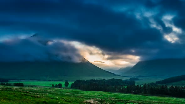 Foggy dawn over the mountains of Glencoe in Scotland, 4k, timelapse