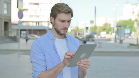 Portrait of Man Using Digital Tablet Outdoor
