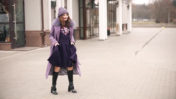 Trendy Lady in All Violet and Purple Dancing in the Street.