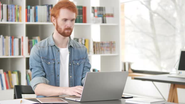 Busy Casual Redhead Man Working On Laptop