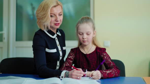 Teacher and a schoolgirl in the classroom