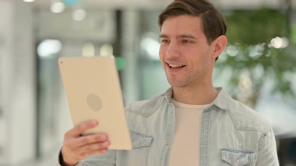 Portrait of Video Call on Tablet By Creative Young Man