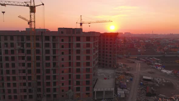 Construction Site in the Middle of the City and Private Houses at Sunset in