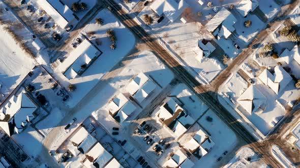 A quiet sunny afternoon in snowy small town streets.