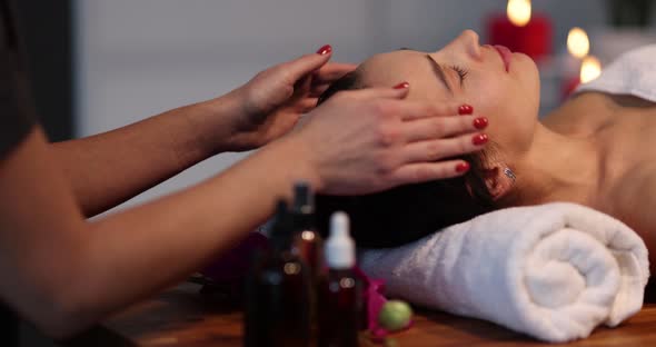 Cosmetologist Makes Relaxing Massage with Spasm of Muscles of Forehead of Face