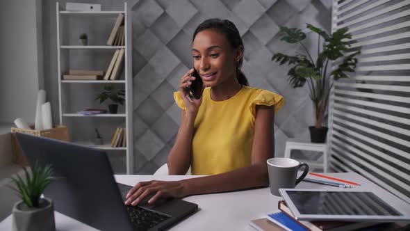 Young Woman Telecommuting at Home Office