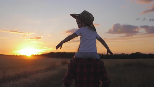 Mother and Little Son Silhouettes Playing on Meadow. Happy Family Concept.