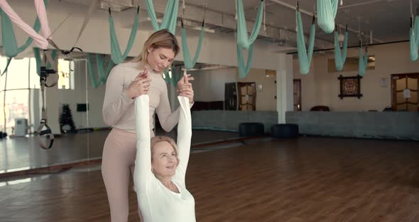 Pregnant Woman and Her Personal Trainer Doing Stretching Exercises