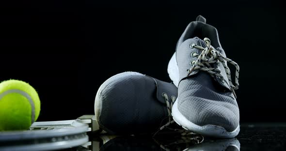 Tennis balls, racket and sports shoe in studio 4k