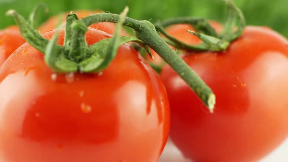 Cherry tomatoes close-up. Rotating on a green background Macro shot.