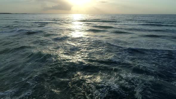 Flying Over Sea Waves and Sunset Sky Background. Drone Shot