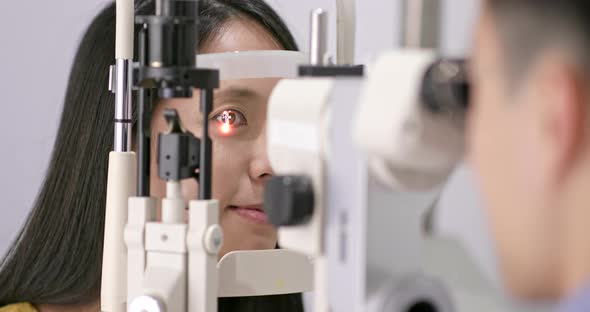 Young Woman checking on eye in clinic