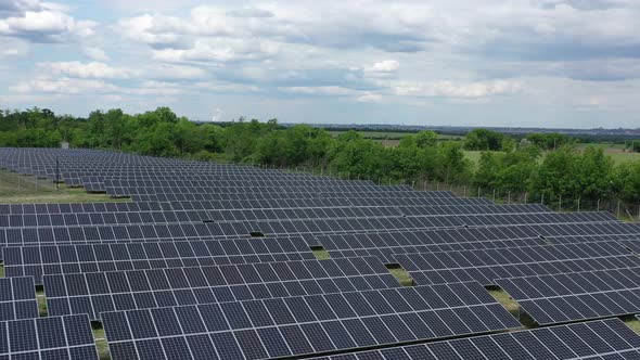 Massive Solar Power Station in the Field, Lots of Solar Panels, Aerial Shot