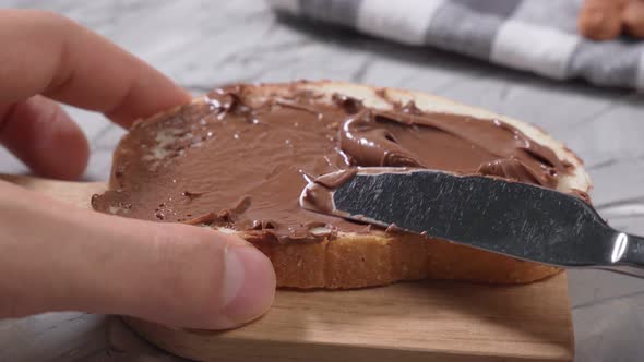 Sliced White Bread with Smeared Chocolate Butter Natural Chocolate Paste with Cocoa During Breakfast