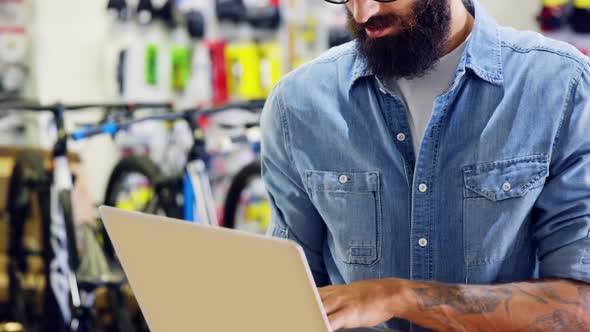 Mechanic using laptop in workshop