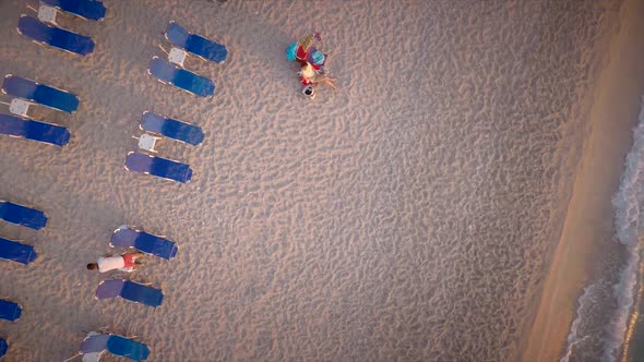 Aerial view of people sitting on deckchairs in front of the sea in Lefkas island