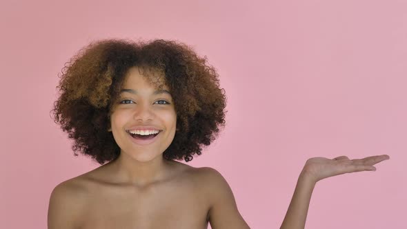 African American Model Raises Hand with Amusement and Smile