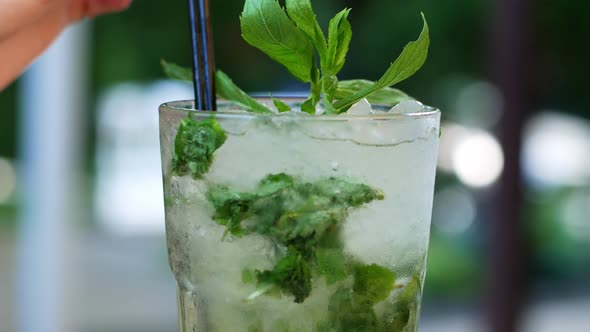 Mojito. Close up a misted glass of mojito with lime slices and mint leaves. Summer drink