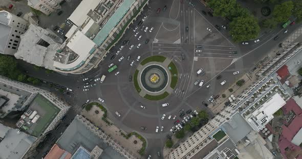 Rotating aerial down shot of a traffic driving the roundabout - Freedom Square.
