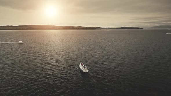 Sun Over Sail Yacht at Open Sea Aerial